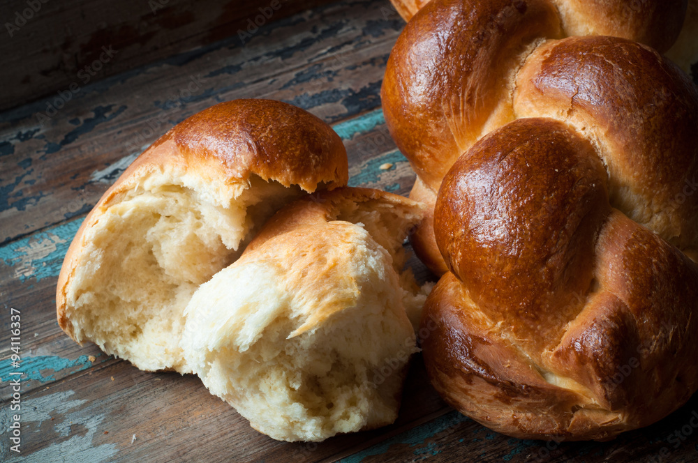 Freshly baked crusty bread served on a rustic wooden table. Freshly baked crusty bread served on a rustic wooden table.