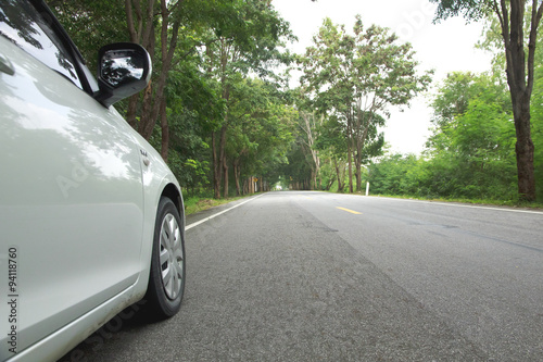 Stock Photo:.Car on asphalt road on summer day at park © singkamc