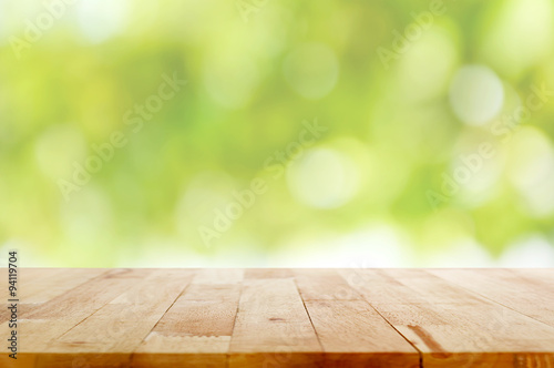Wood table top on green bokeh abstract background