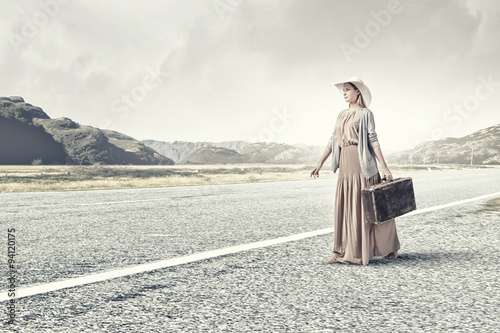 Woman with old suitcase