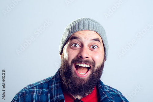 young bearded man lokking amazed in to the camera