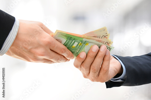 Billede på lærred Businessman hands passing money, Euro currency (EUR)