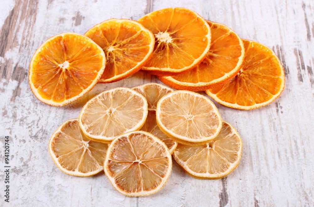 Slices of dried lemon and orange on old wooden background Slices of dried lemon and orange on old wooden background