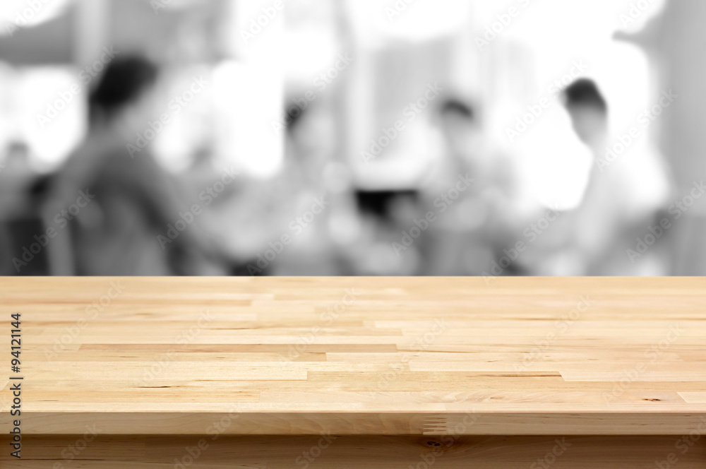 Wood table top on blurred monochrome background of people in cafe Wood table top on blurred monochrome background of people in cafe