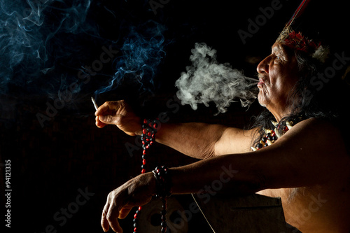 Photos An old shaman from an indigenous tribe in the Amazon rainforest of Ecuador leads a ceremonial ritual with ayahuasca, surrounded by tribal people
