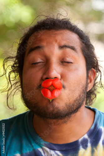 Afroman showcasing his charm with a captivating hot lips flower,also known as the kiss flower. photo