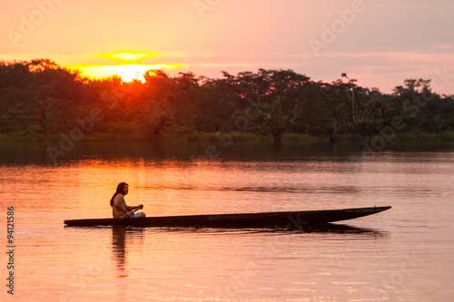 ecuador amazon people tribe indigenous biodiversity canoe boat cuyabeno amazonia indigens mature male with canoe on laguna grande cuyabeno national park ecuador at sunset ecuador amazon people tribe