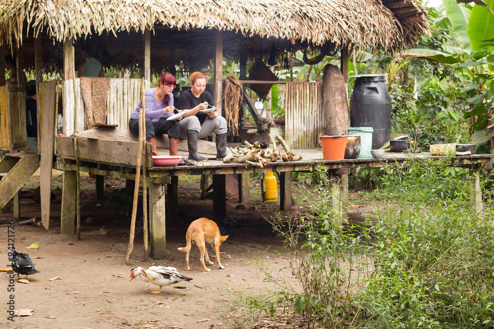 travelers having brunch in typical shelter dining room in the amazonian
