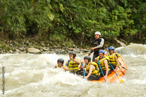 Thrilling white water rafting in Ecuador's rapids, as adventurous people navigate the rushing river amidst breathtaking water splashes.
