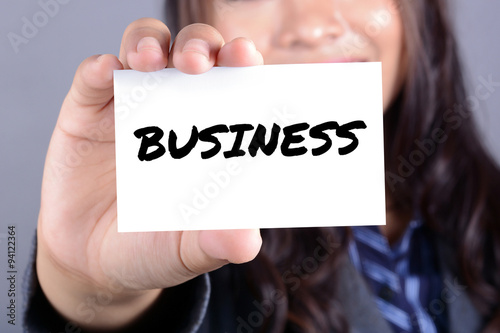 Businesswoman showing card with a word BUSINESS