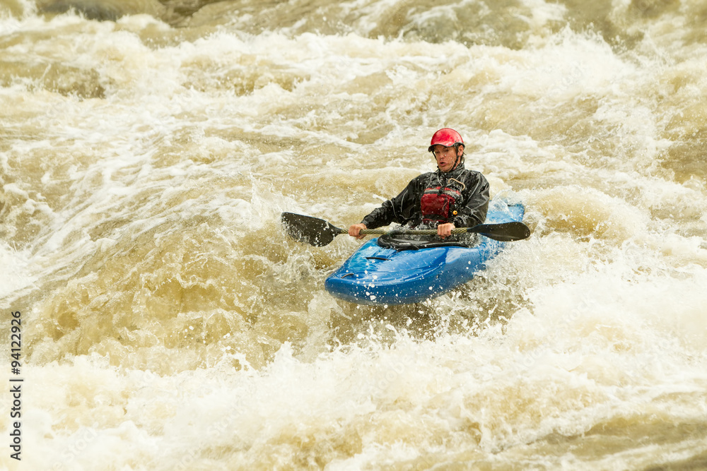 A thrilling image of a white-water kayak navigating through extreme rapids, splashing water everywhere as the adrenaline-fueled sport of rafting is enjoyed.