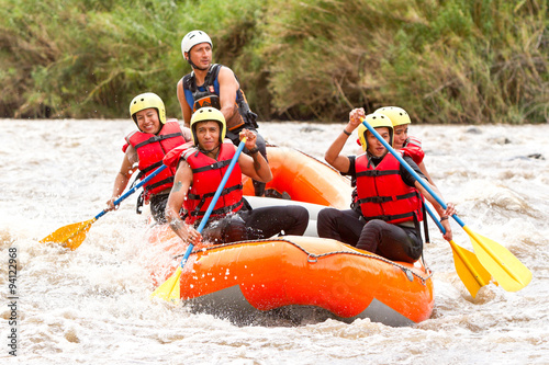 A group of friends in a white raft navigate the flowing waters, united in their love for rafting and adventure.
