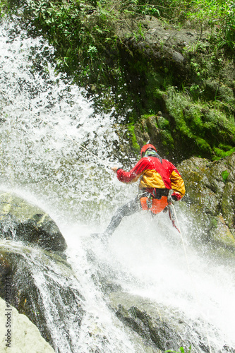 Fototapeta Naklejka Na Ścianę i Meble -  Experience the thrill of a waterfall descent guided by a highly skilled and experienced canyoning instructor,ensuring a safe and exhilarating adventure.