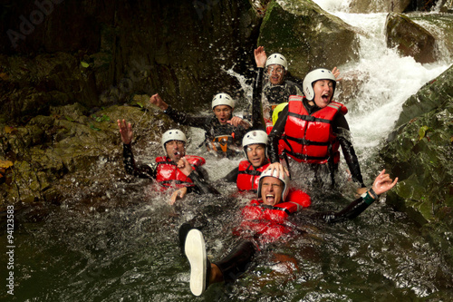 outdoor canyoning active group adventure water sport fun expedition river partnership of energetic teenage human during a canyoning expedition in ecuadorian rain forest outdoor canyoning active group