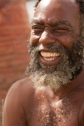 Capture the joy of an Afro American senior man with a radiant smile,exuding happiness and positivity.