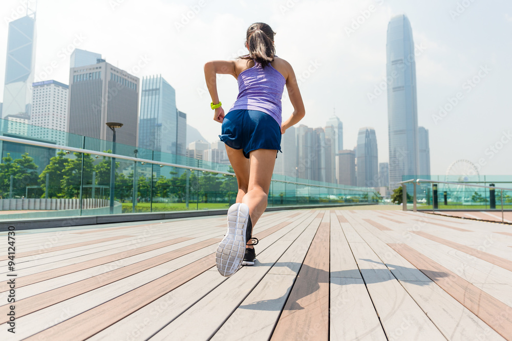 The back view of the woman running in a city The back view of the woman running in a city