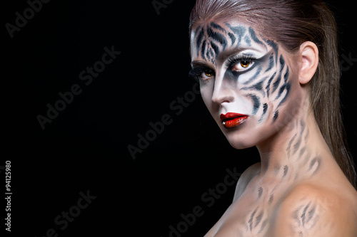 Woman with tiger face in halloween concept