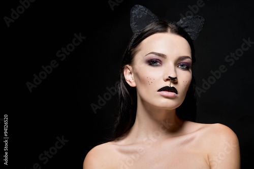 Beautiful young woman dressed as a cat. Make up cat. Halloween 