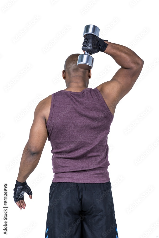 Fit man exercising with dumbbell Fit man exercising with dumbbell