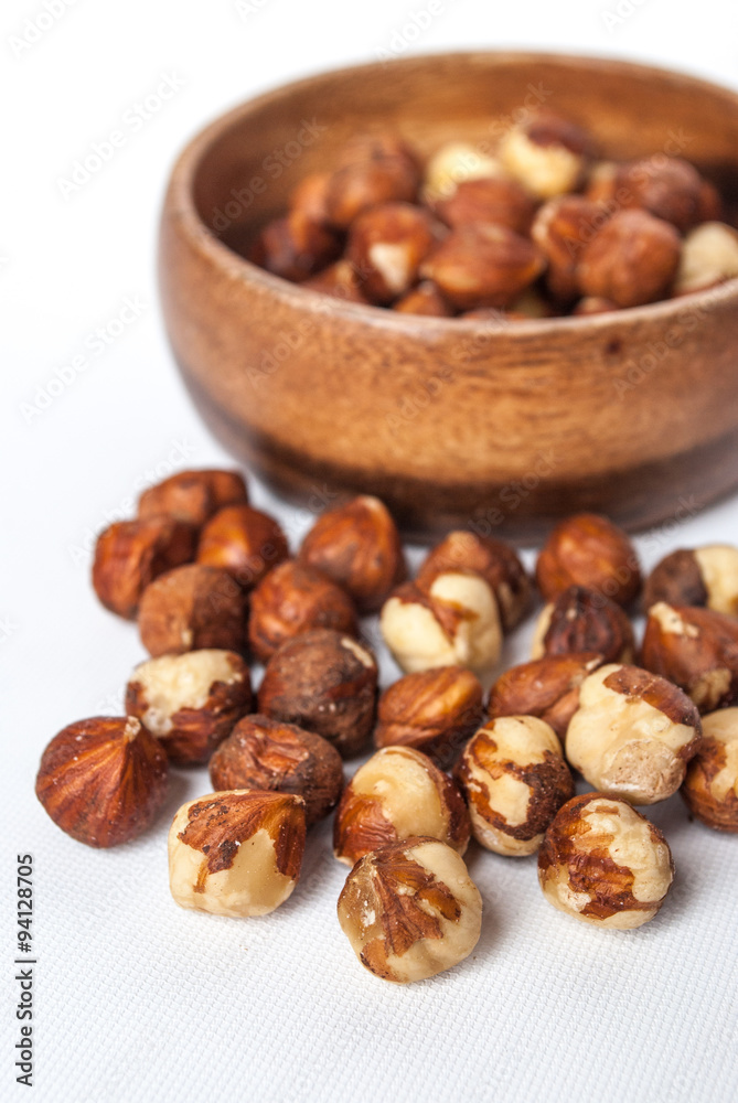 Hazelnuts in a Wooden Bowl on White Background Hazelnuts in a Wooden Bowl on White Background