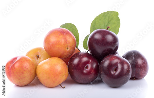 Ripe yellow and cherry plums