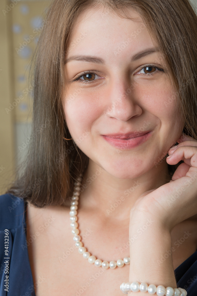 Naklejka premium Portrait of a cute girl in a blue dress