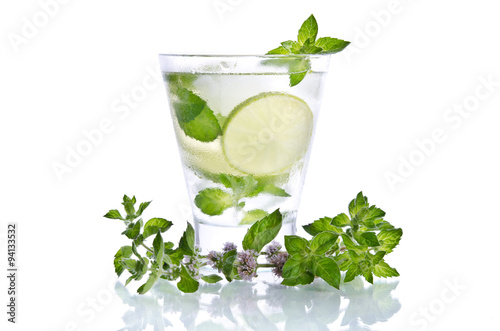 small glass of mojito with ice mint and lime on white background