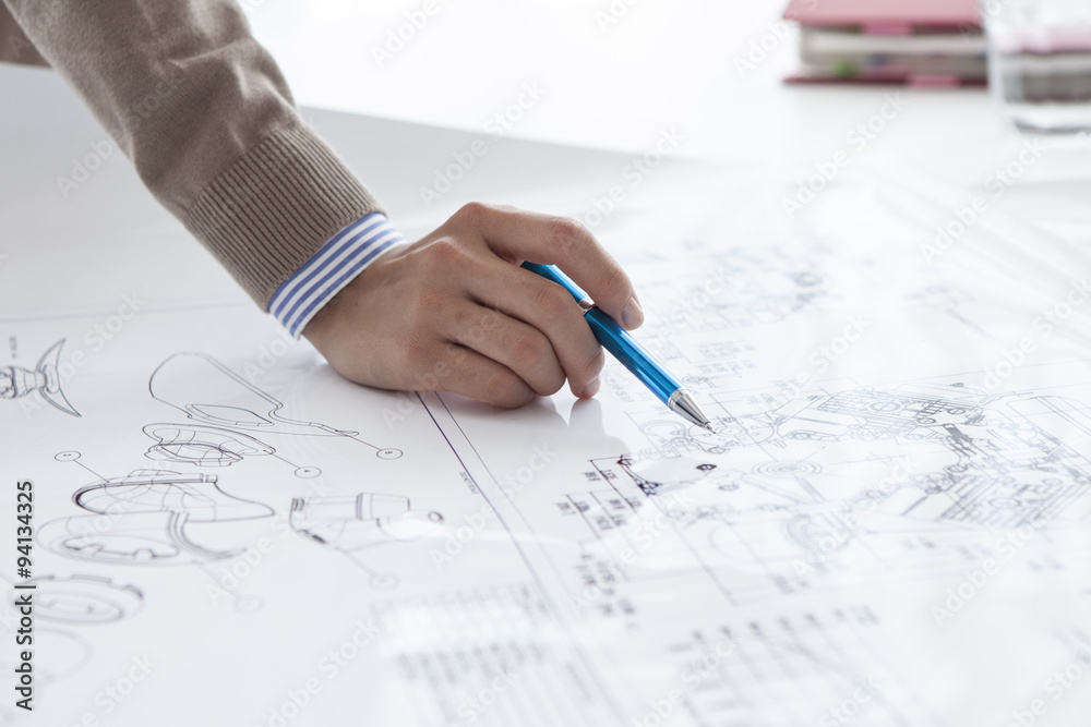 The hands of the woman pointing to the drawings The hands of the woman pointing to the drawings