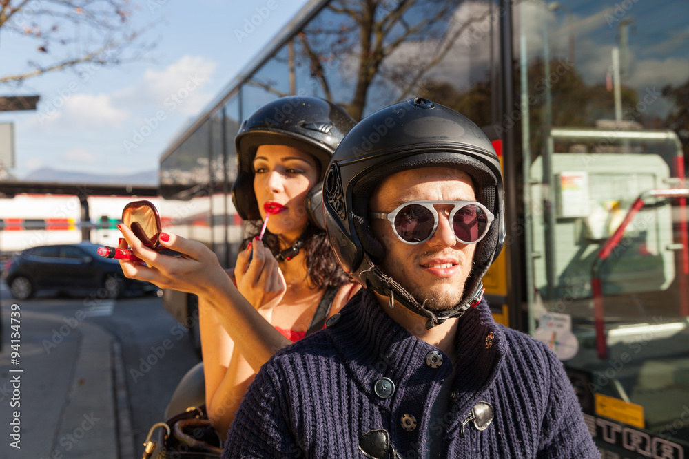 Young couple moving in traffic, she puts on lipstick Young couple moving in traffic, she puts on lipstick
