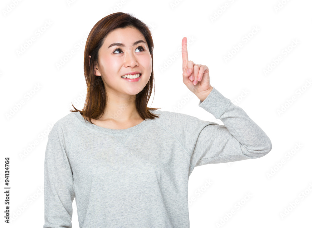Young Woman looking at the finger point up Young Woman looking at the finger point up