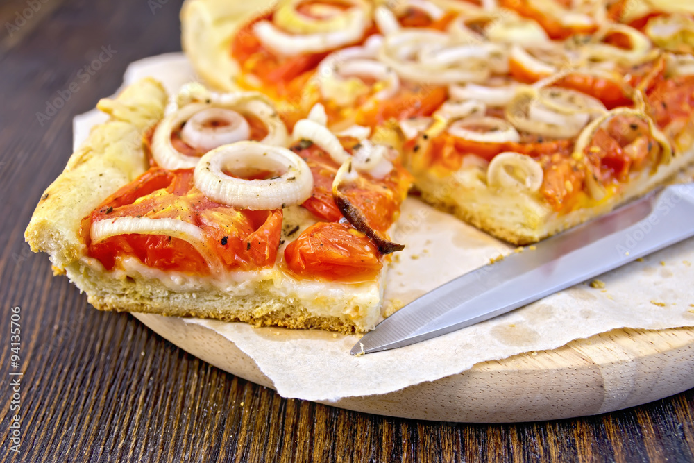 Pie with onions and tomatoes on parchment Pie with onions and tomatoes on parchment