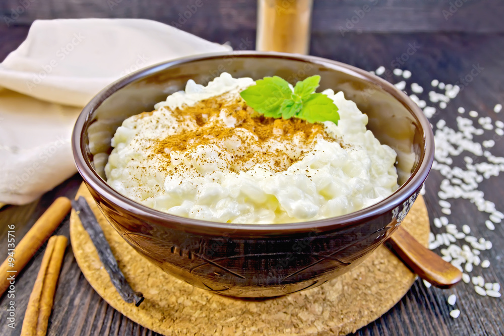 Rice porridge with cinnamon in bowl on board Rice porridge with cinnamon in bowl on board