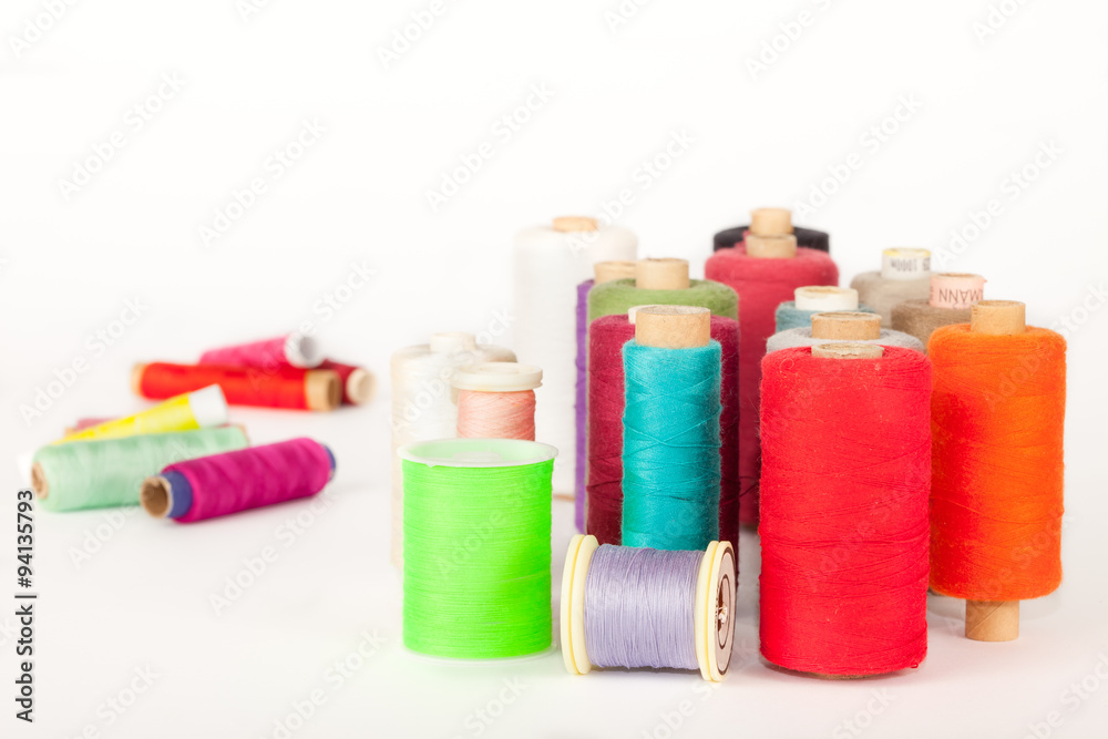 Pile of bobbins of colorful threads Pile of bobbins of colorful threads
