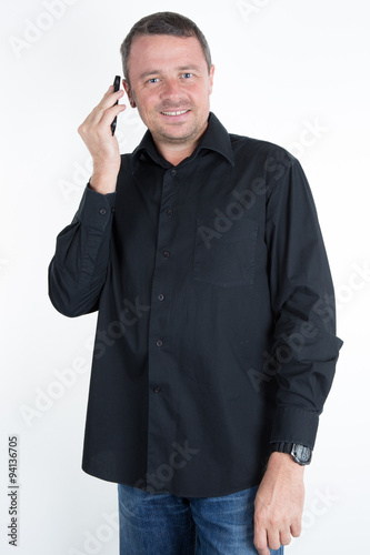 Happy smiling young man talking on mobile isolated on white background