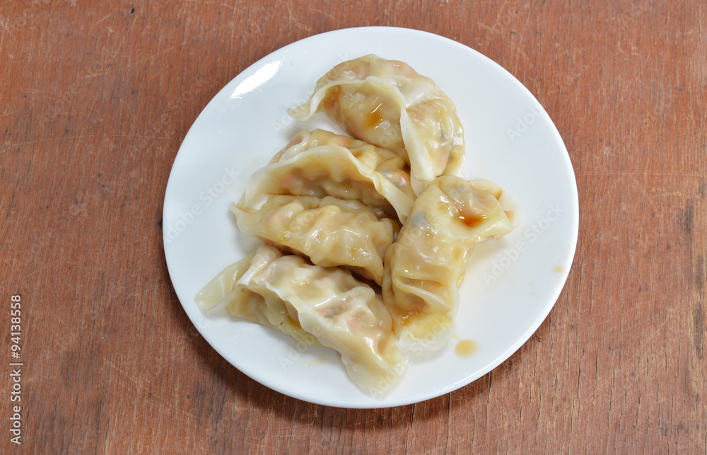 vegetarian Chinese dumpling dressing soy sauce on dish vegetarian Chinese dumpling dressing soy sauce on dish