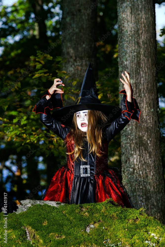 Girl in the forest dressed Halloween witch costume Girl in the forest dressed Halloween witch costume