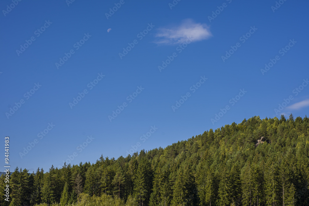 Mountain landscape in the early morning sky with clouds