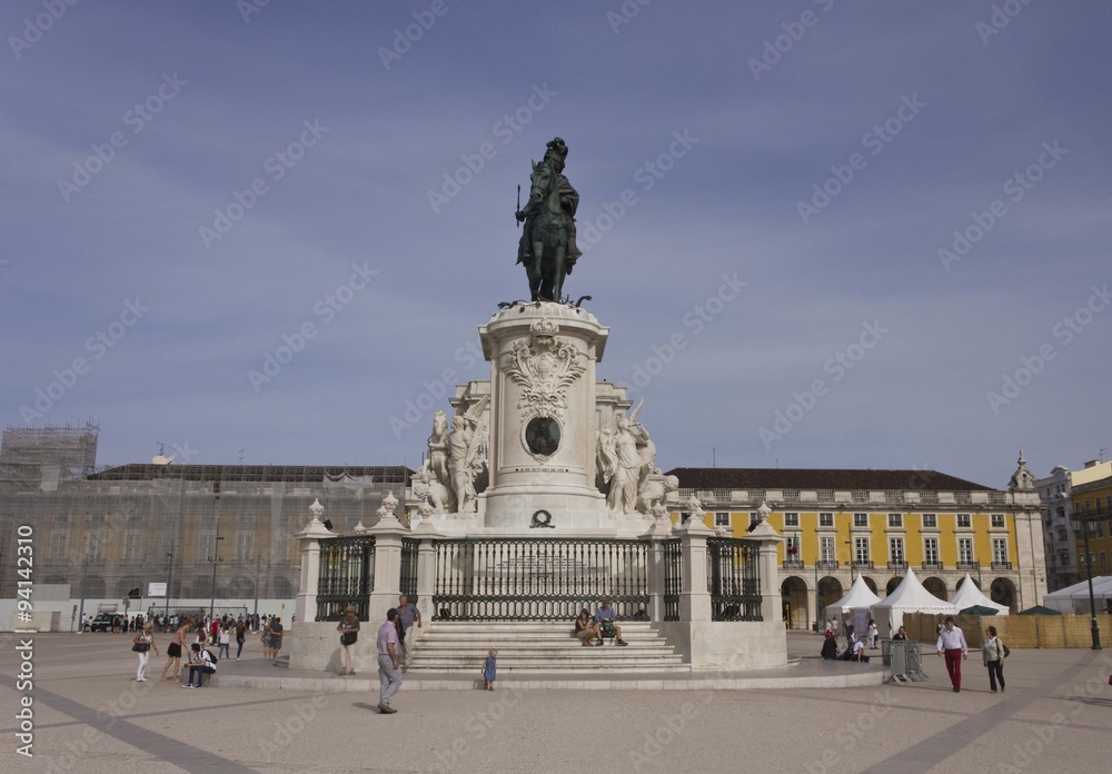 People walking in Lisbon commercial square, with the King Jose equestrian Statue in the background
