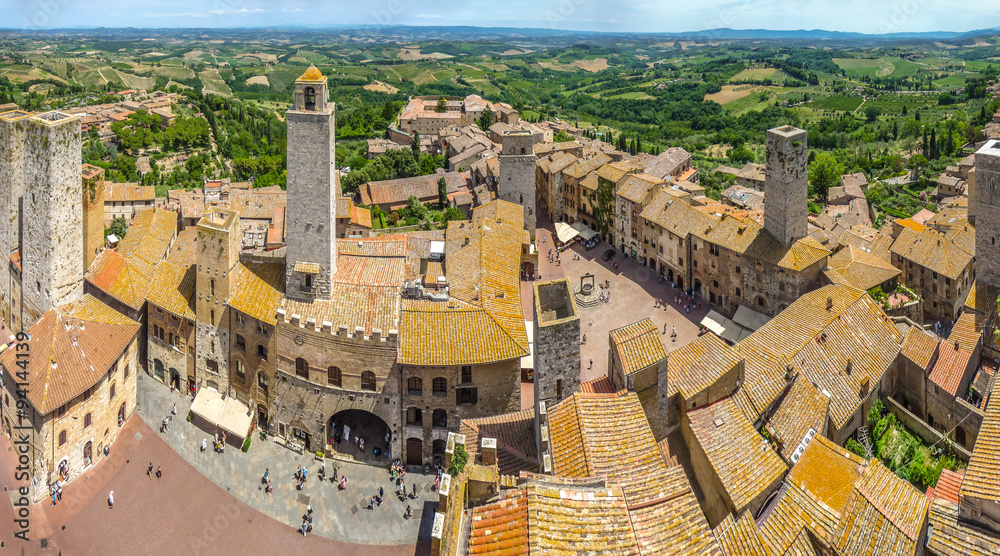 Medieval town of San Gimignano with Tuscan countryside on a sunny day, Tuscany, Italy