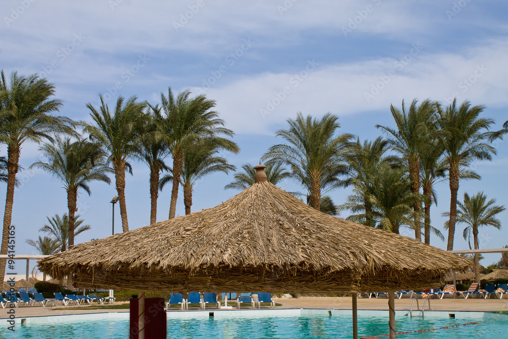 tropical resort with palm trees against the sky tropical resort with palm trees against the sky