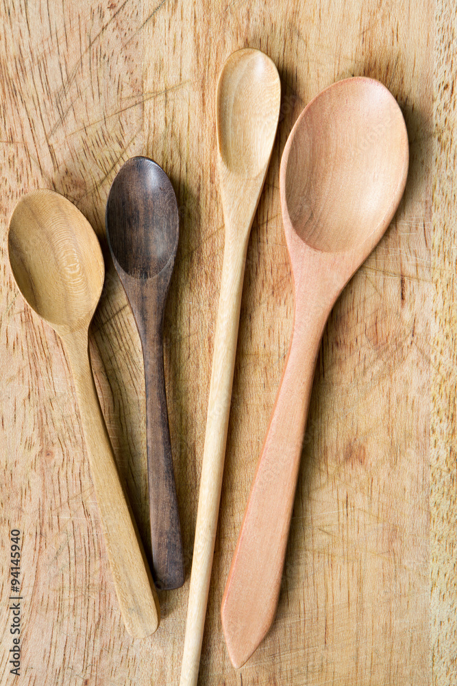 Wooden spoon and fork on wooden cutting board. Wooden spoon and fork on wooden cutting board.