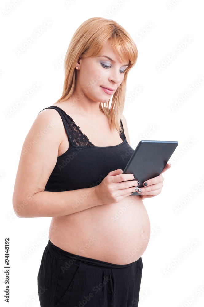 Modern pregnant woman using wireless tablet pc or pad Modern pregnant woman using wireless tablet pc or pad