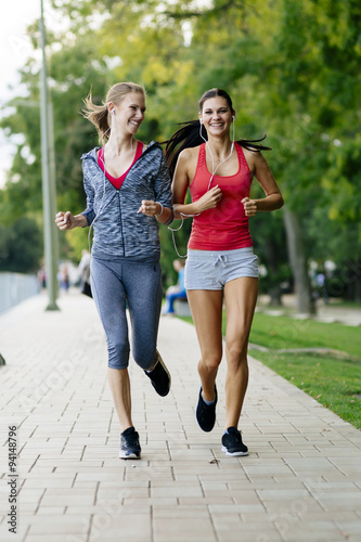 Two women jogging in park © NDABCREATIVITY