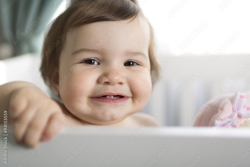 Infant baby resting and playing in his little baby bed Infant baby resting and playing in his little baby bed