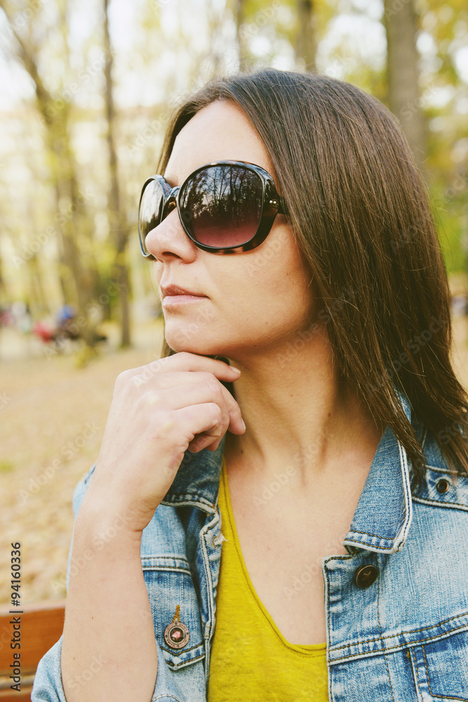 Fototapeta premium Hipster beautiful girl in jeans jacket . Fashion girl posing with jacket