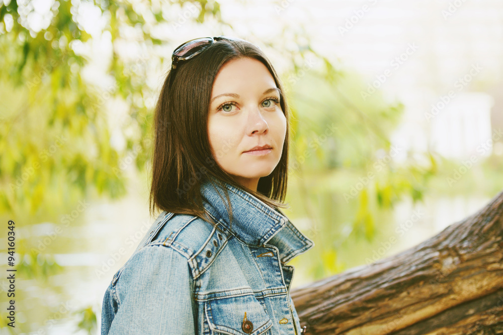 Hipster beautiful girl in jeans jacket . Fashion girl posing with jacket Hipster beautiful girl in jeans jacket . Fashion girl posing with jacket