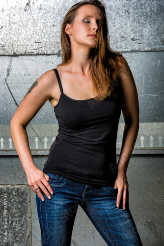 Trendy Woman in blue jeans posing in the grungy underground © Manuel Findeis