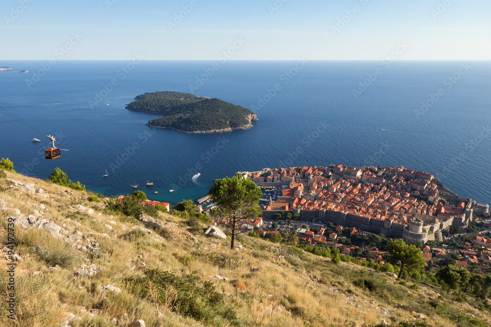 View of a cable car, the walled Old Town of Dubrovnik and Lokrum Island in Croatia from above.