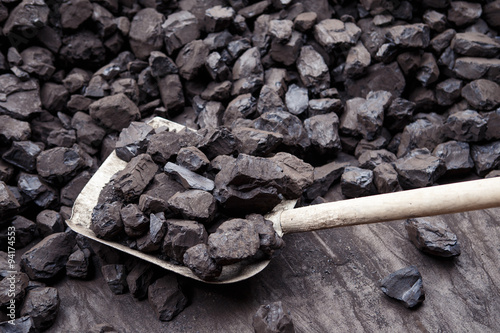 Shovel and coal in the background coal mine photo