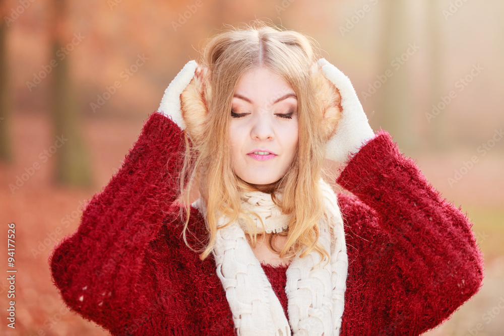 Portrait of pretty relaxed woman in earmuffs. Portrait of pretty relaxed woman in earmuffs.